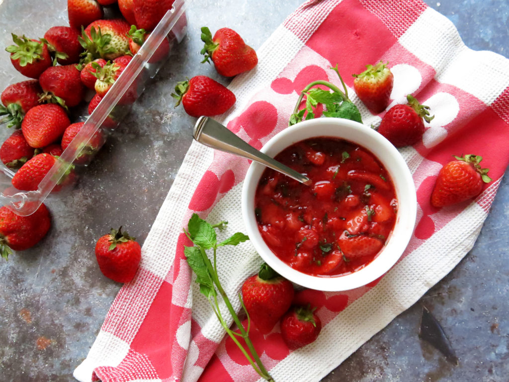 Strawberry Mint Compote surrounded by strawberries