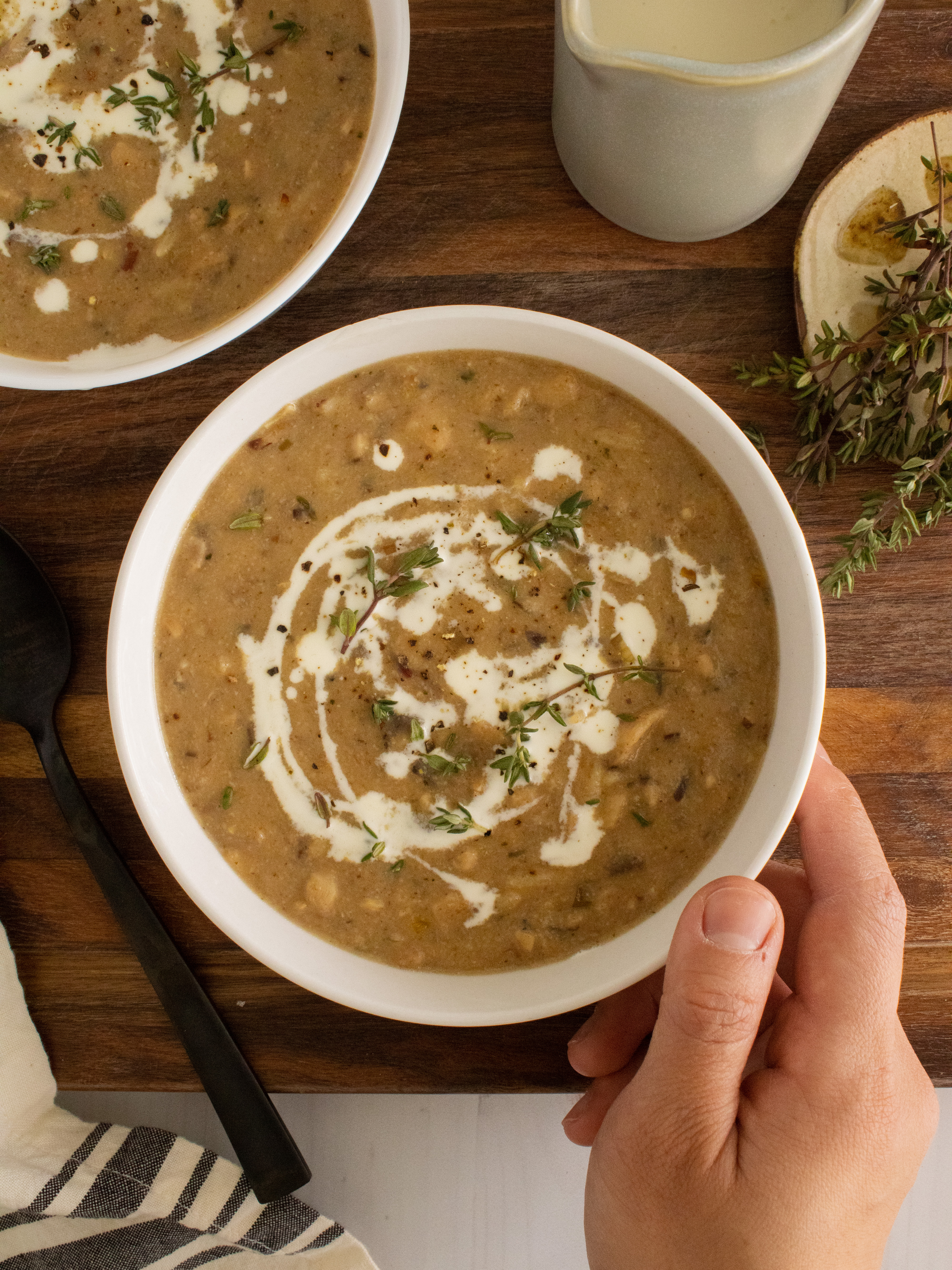 holding a bowl of Creamy Mushroom Wild Rice Soup