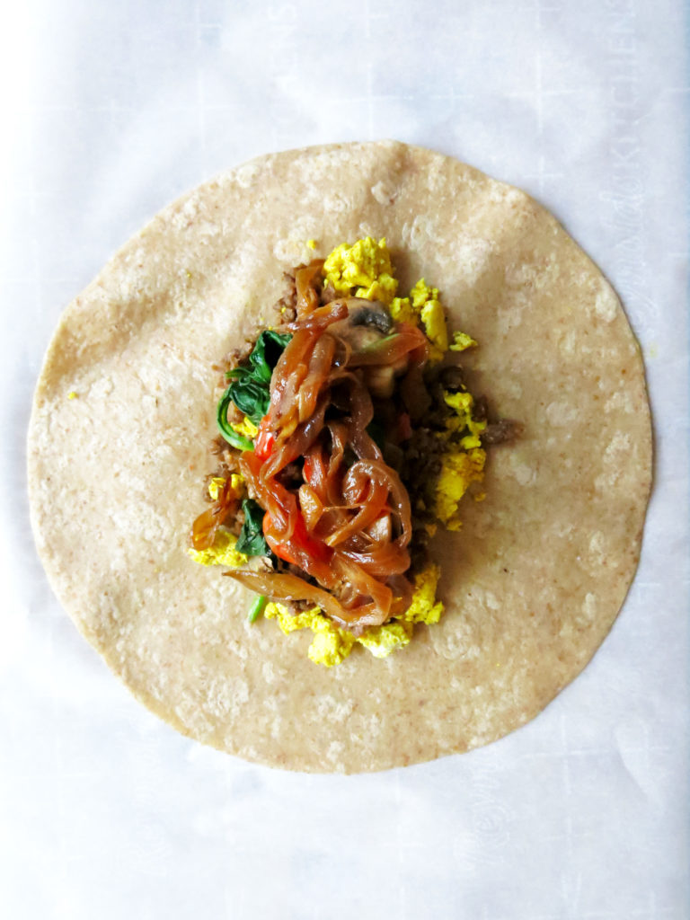 Cross section of Vegan Breakfast Burritos with caramelized onions