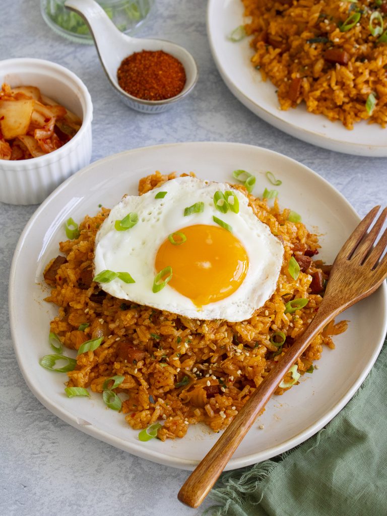 spam and kimchi fried rice on a plate with a fried egg on top