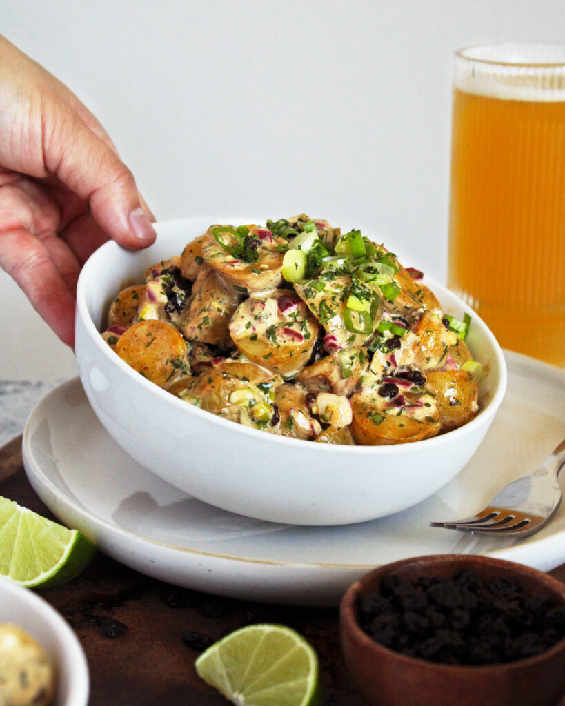 Holding bowl of Spiced Roasted Potato Salad