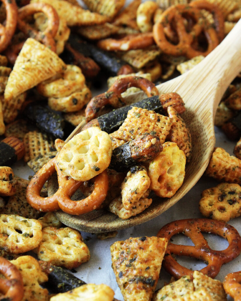 Macro shot ofMiso Furikake Snack Mix on wooden spoon
