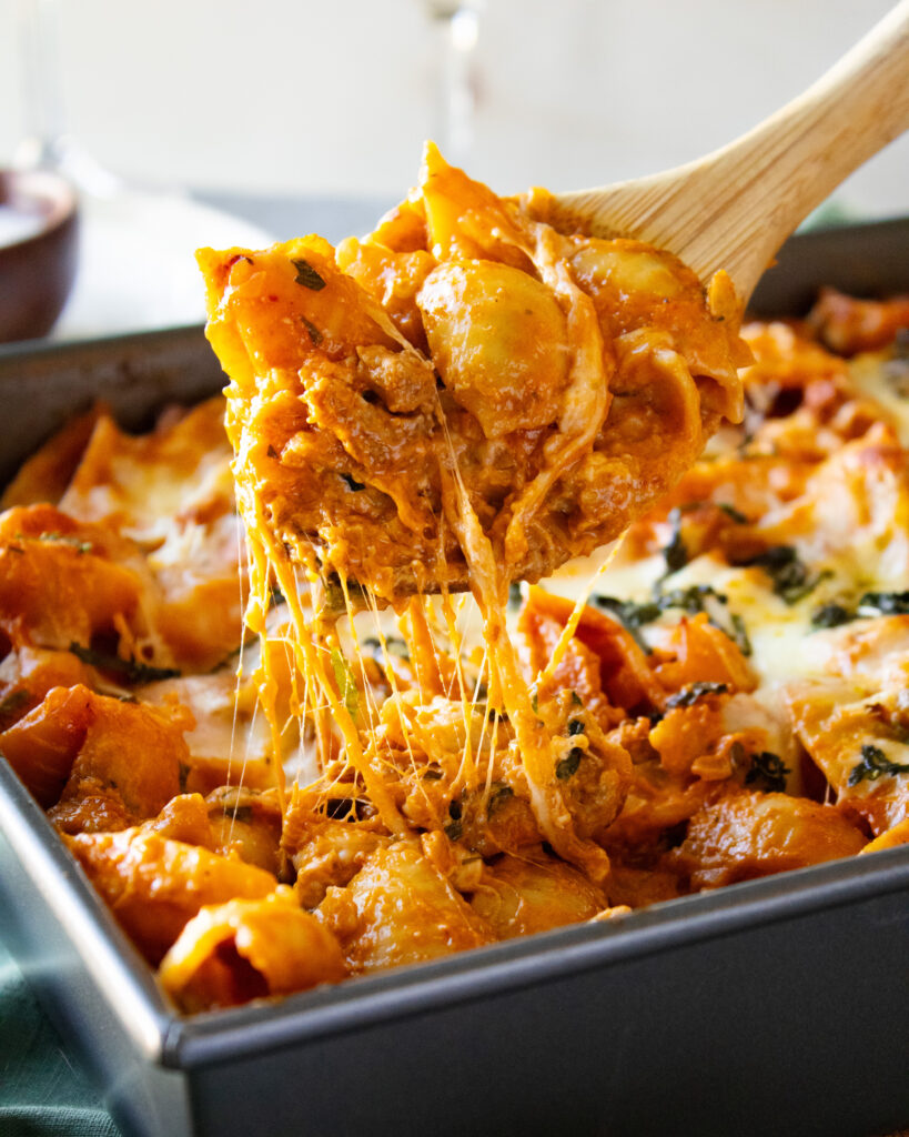 cheese pull spoon shot of Spicy Vodka Pasta Bake