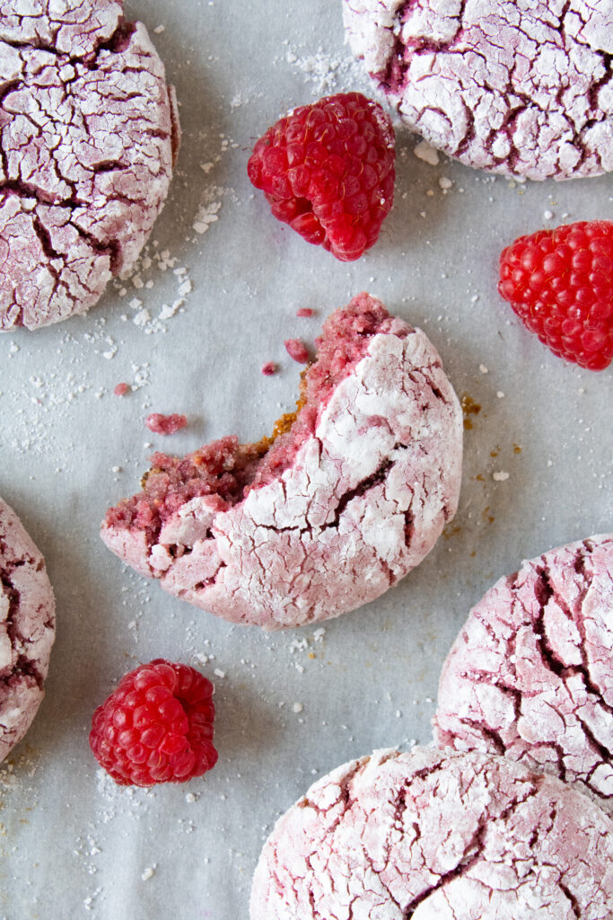 Top down shot of raspberry crinkle cookie with a bite taken out