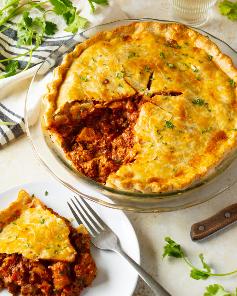 Butter Chicken Pot Pie with a slice taken out on the side