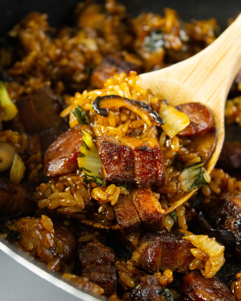 Close up of Pork Belly Sticky Rice on a spoon