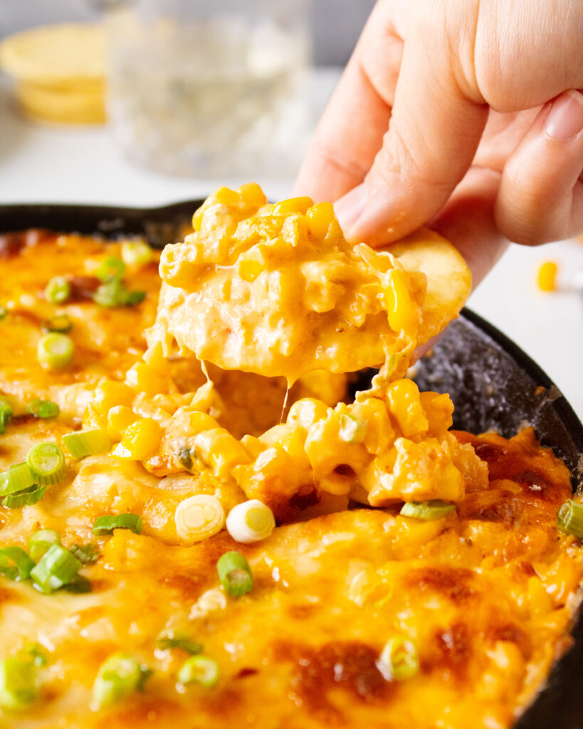 cheese pull of cracker and kimchi corn cheese dip