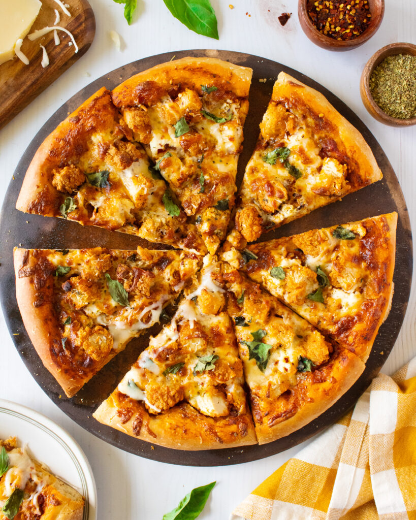 overhead shot of Chicken Parmesan Pizza with some slices missing