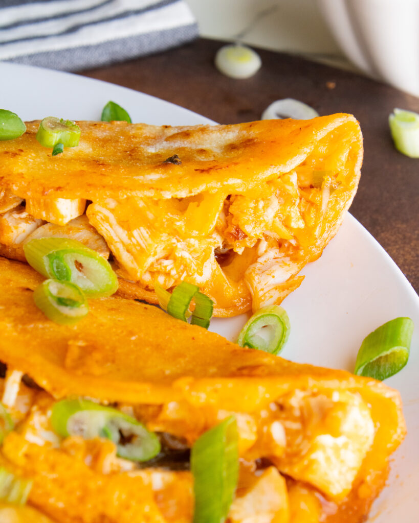 close up of buffalo chicken filling inside taco