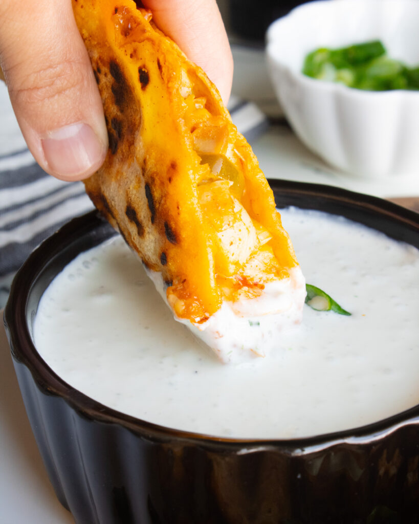 Dipping Spicy Buffalo Chicken Tacos into bleu cheese dipping sauce