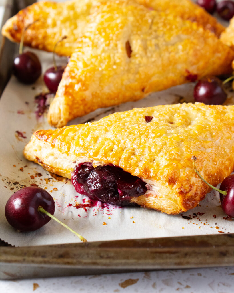 cherry filling oozing from Cherries and Cream Turnovers