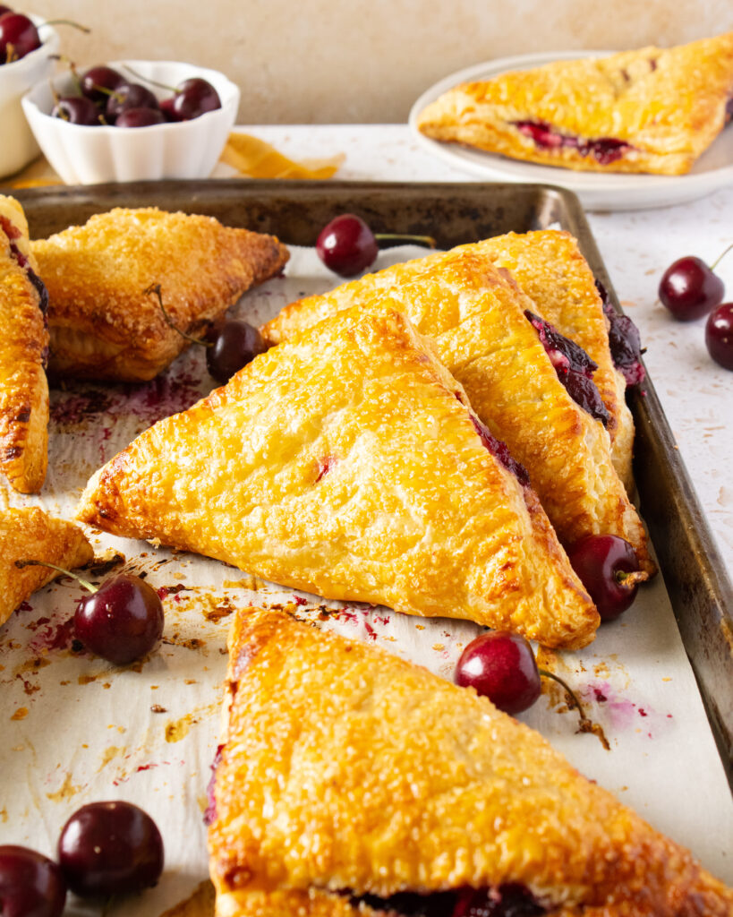 baking sheet of cherries and cream turnovers