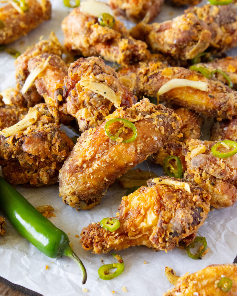 45 degree angle shot of a pile of Salt and Pepper Chicken Wings