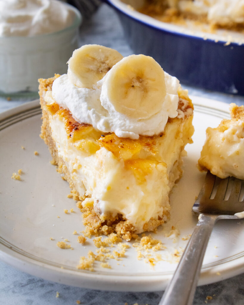 slice of Crème Brûlée Banana Cream Pie with a bite taken out