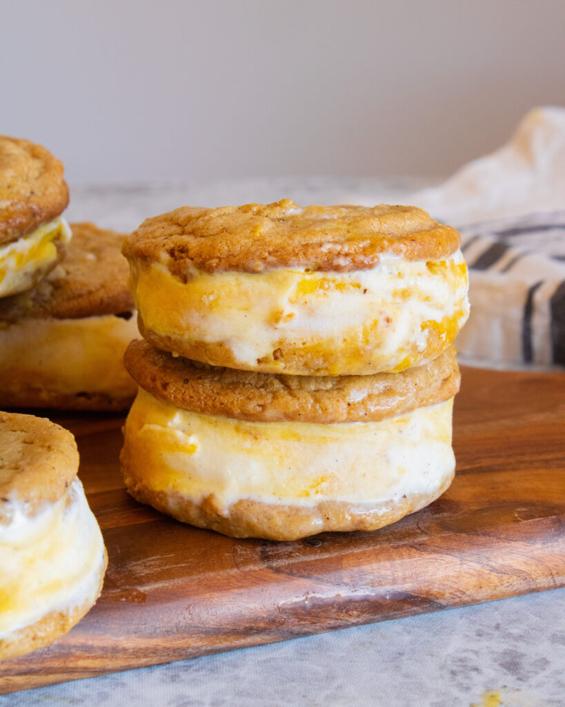 close up of 2 Mango Creamsicle Ice Cream Sandwiches stacked on top of each other
