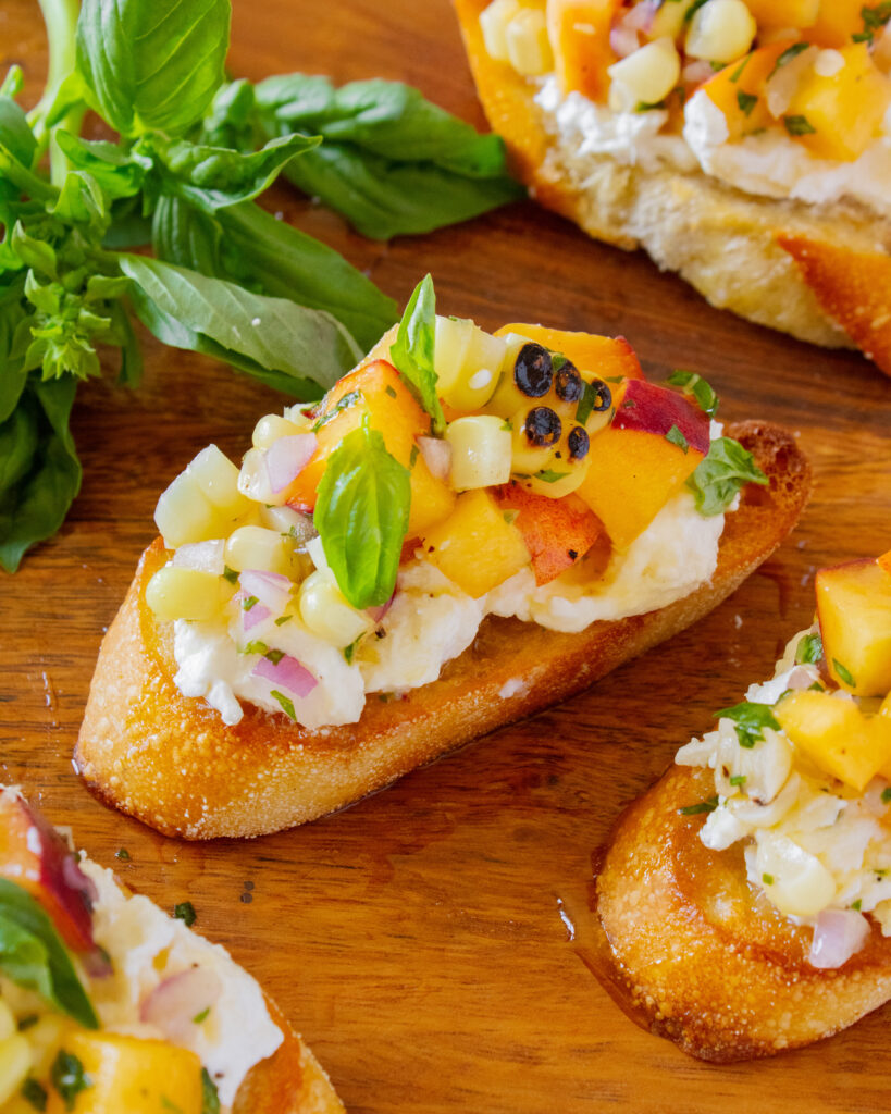 high angle close up of Peach and Corn Burrata Crostini