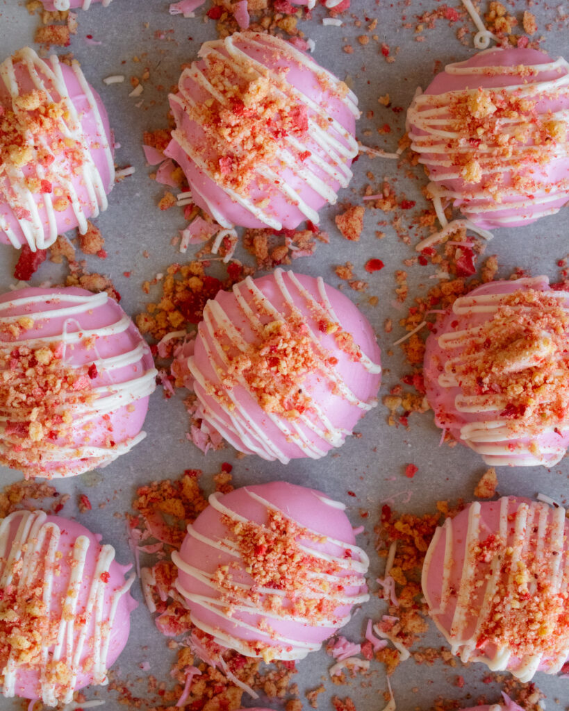 overhead shot of Strawberry Shortcake Cheesecake Truffles on a baking sheet