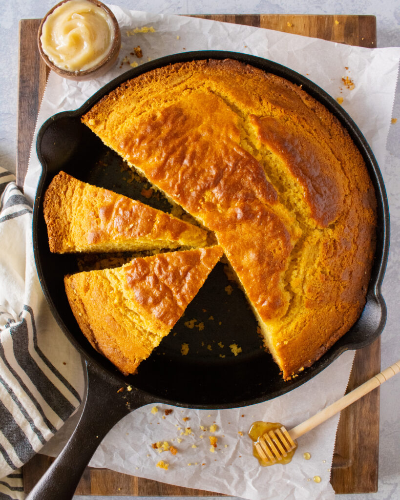 overhead shot of sliced Honey Butter Cornbread in the cast iron skillet