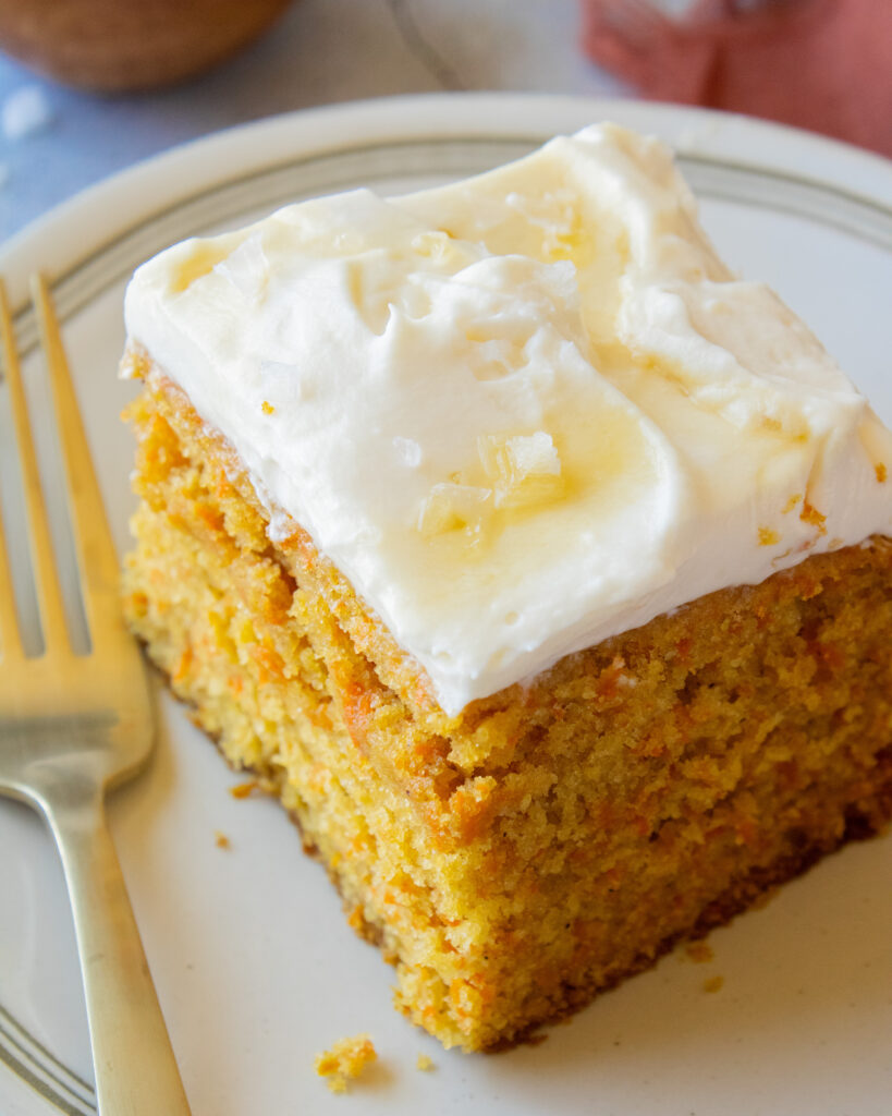 close up of a slice of Tahini Carrot Cake with Salted Maple Whipped Cream
