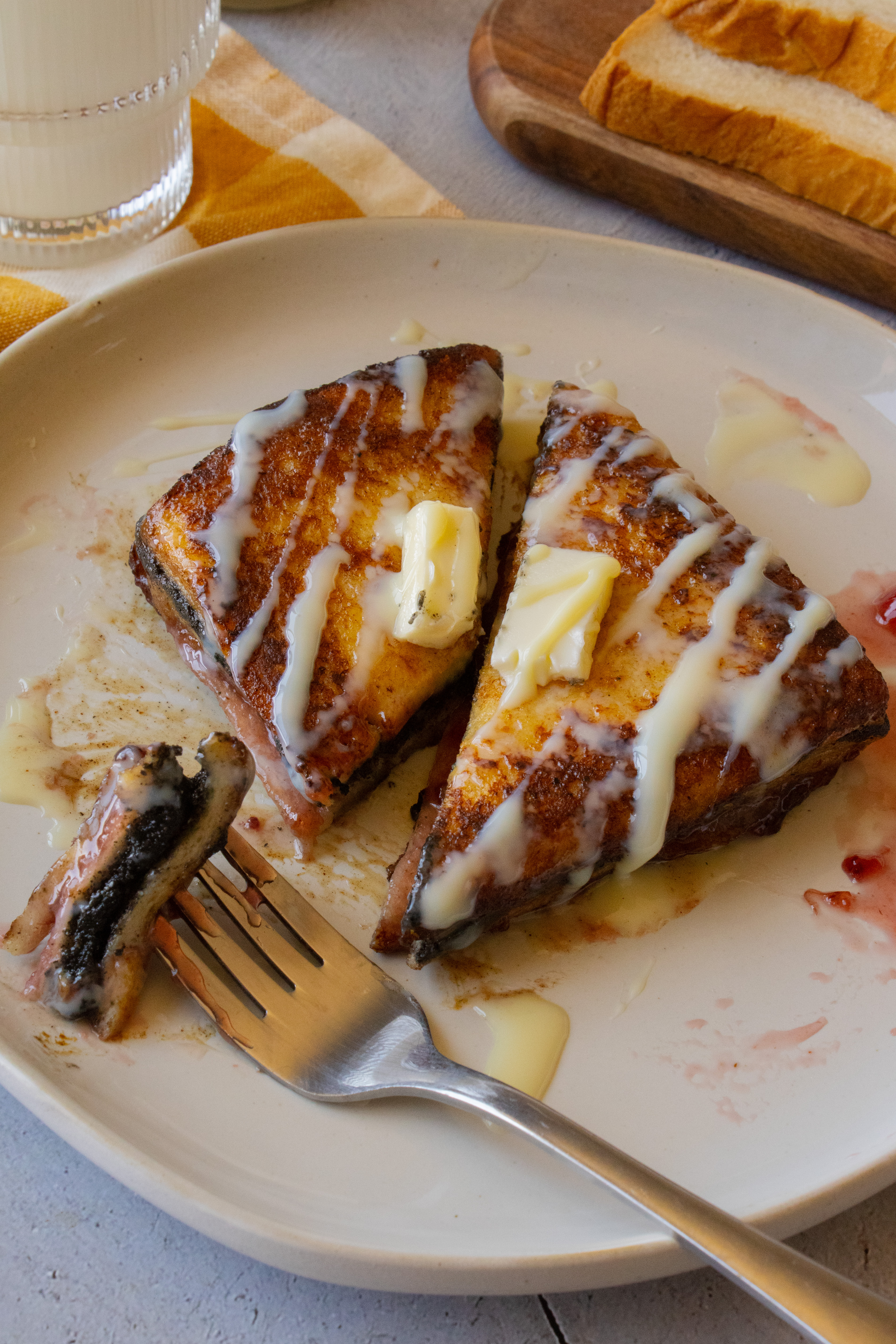 Black Sesame Raspberry Hong Kong Style French Toast cut in half on a plate
