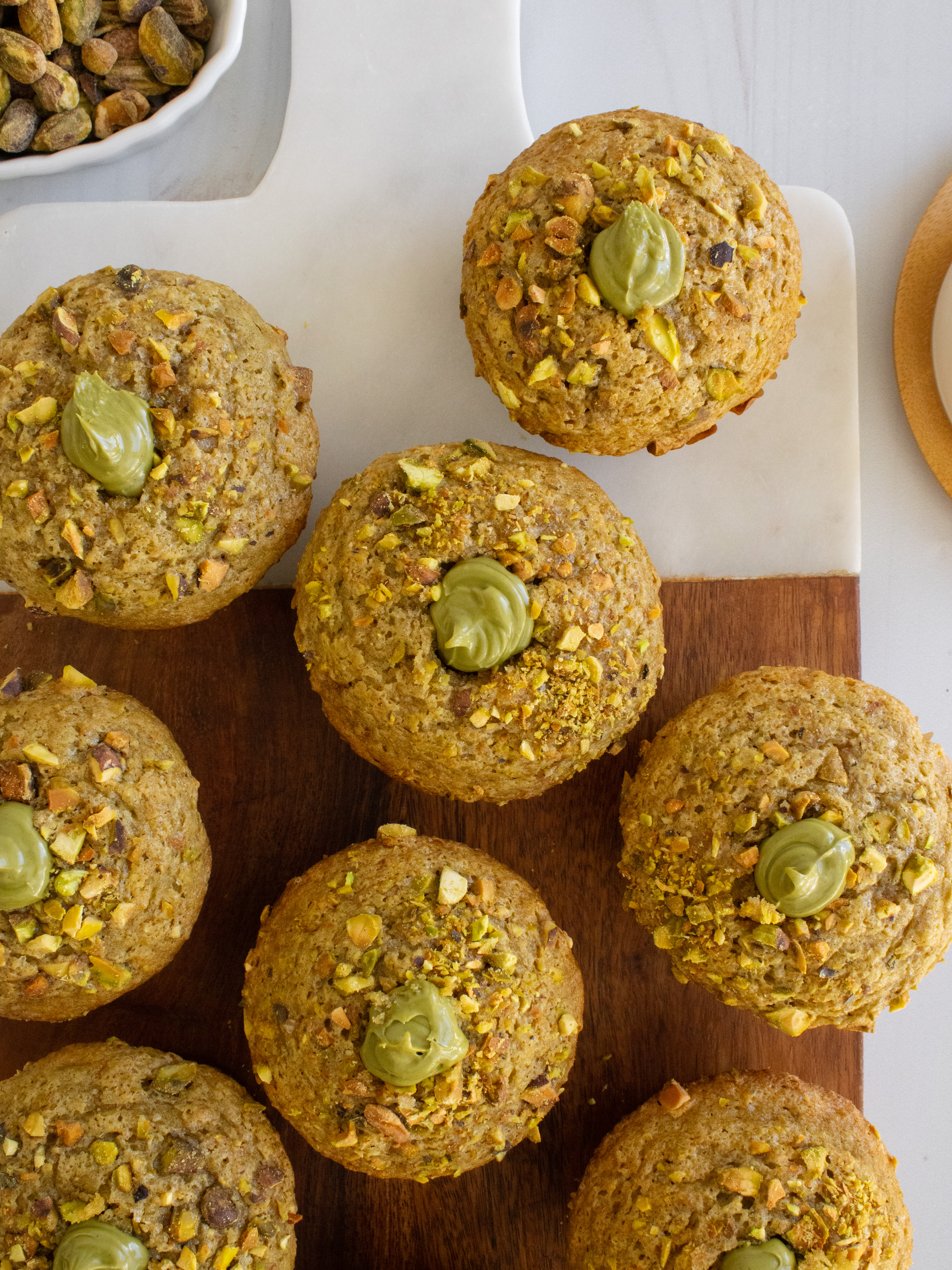 overhead shot of Pistachio Cream Muffins on a cutting board