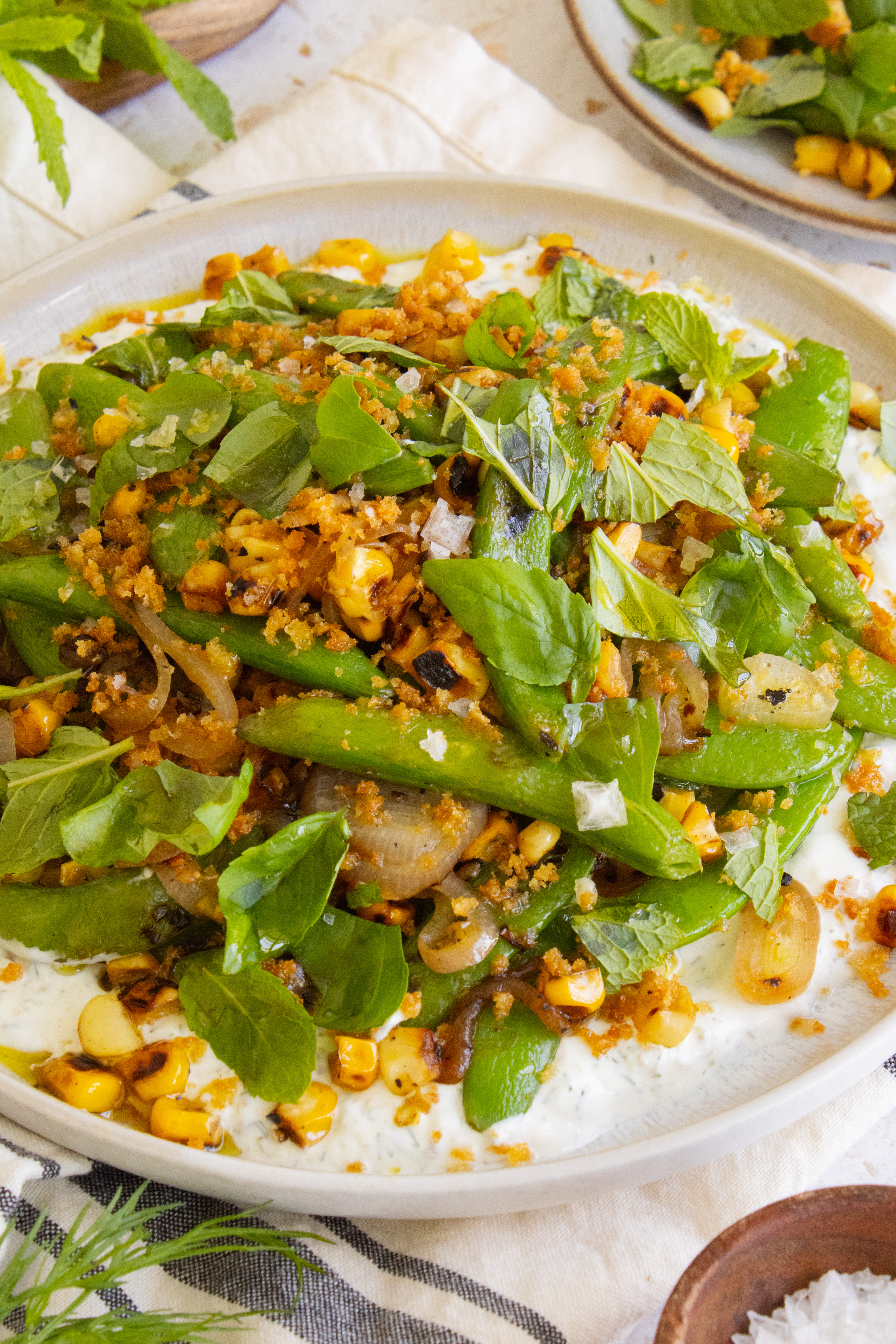 close up 45 degree angle photo of Charred Snap Pea Corn Salad