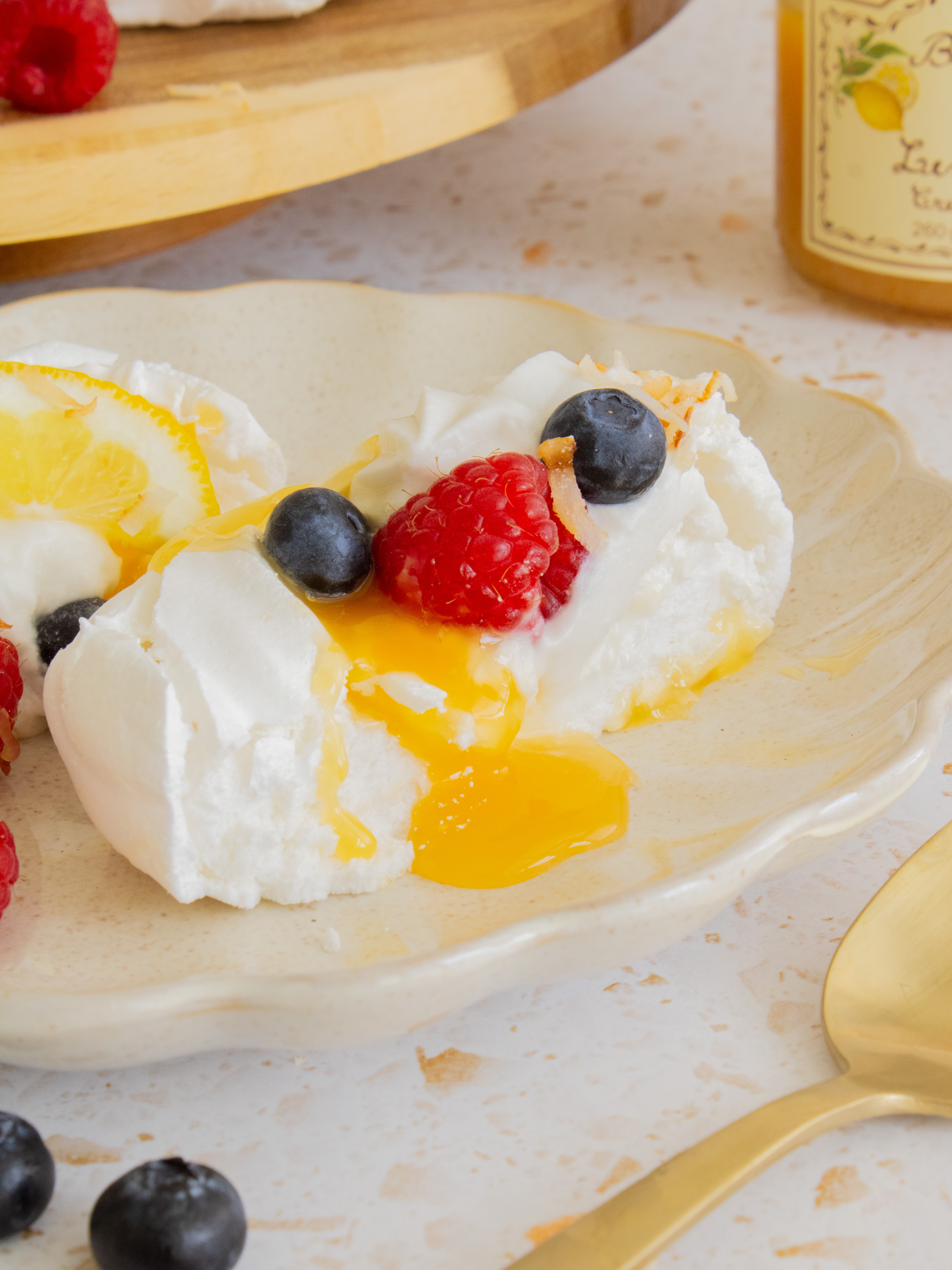 close up of lemon coconut mini pavlovas cut in half