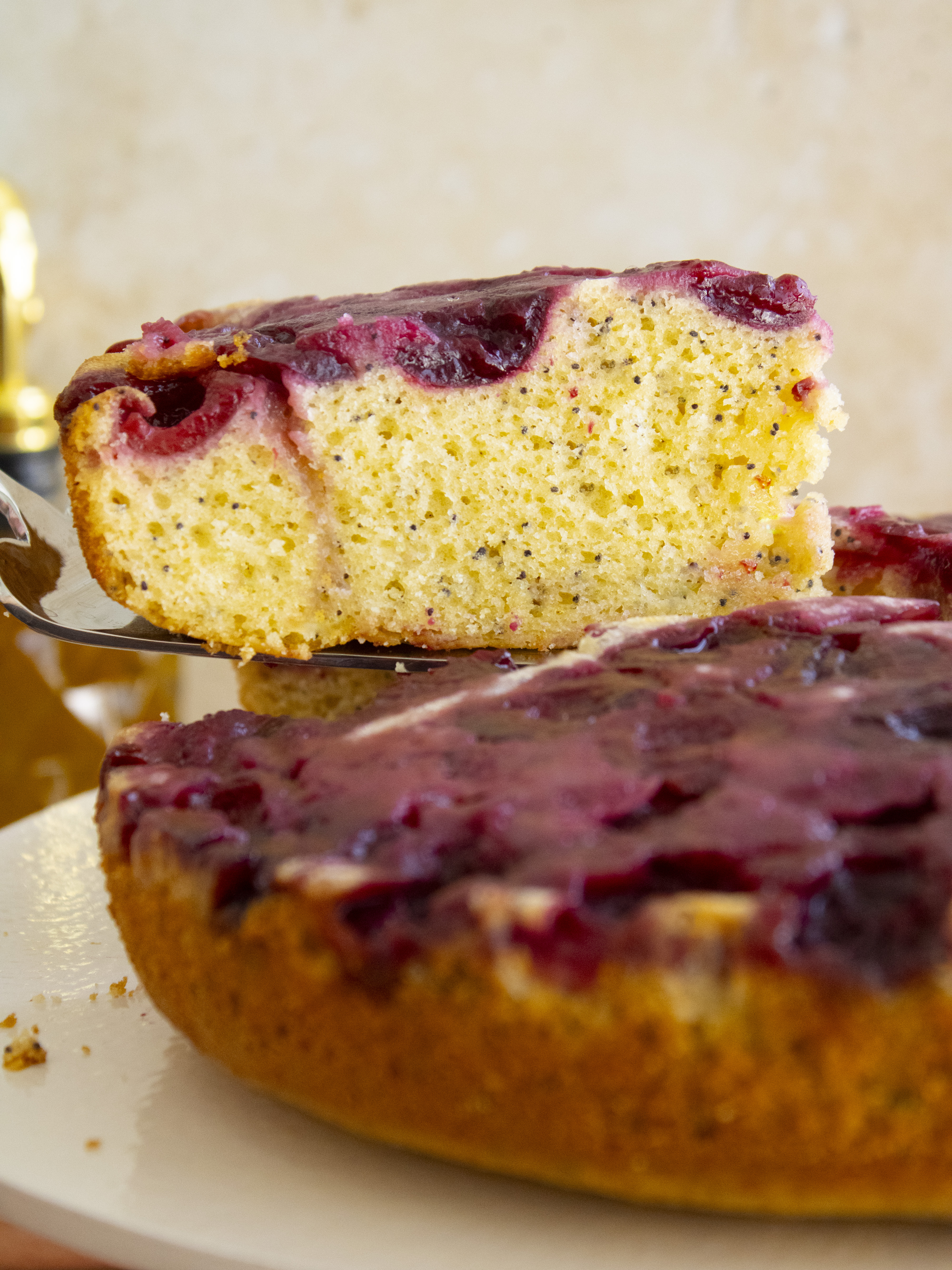 lifting up a slice of Cherry Olive Oil Cake