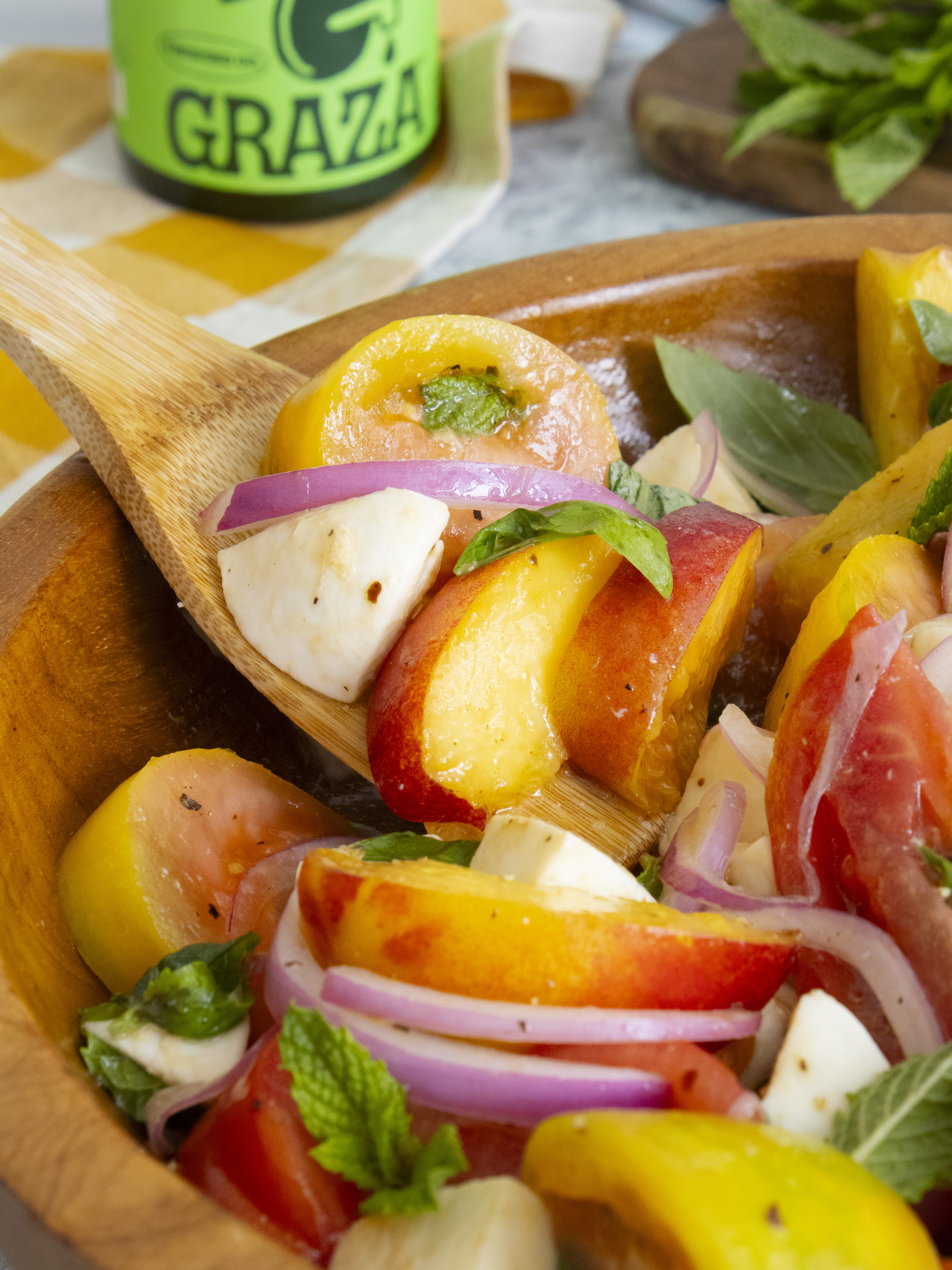 close up of scooping Peach Tomato Salad