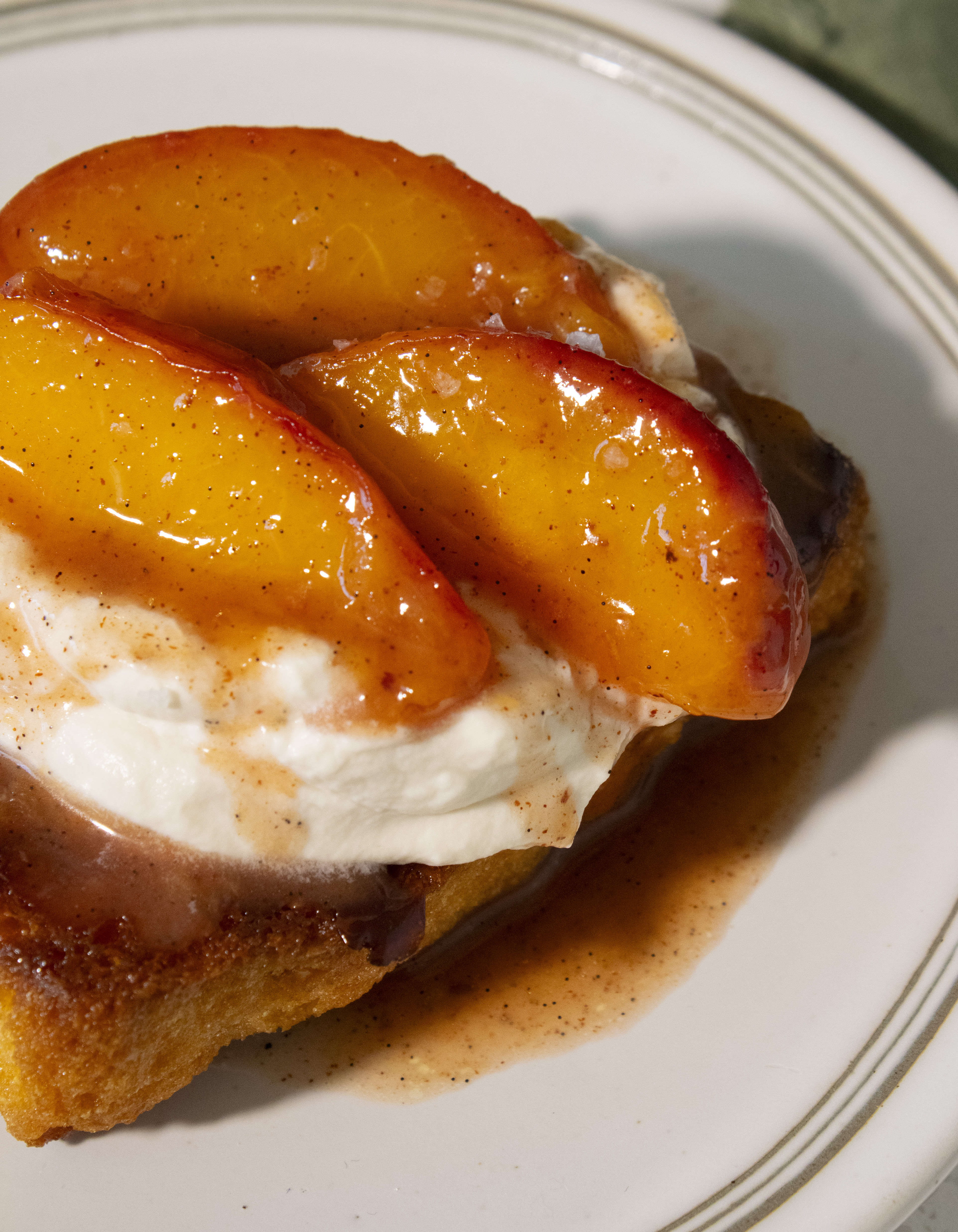 Close up of peaches on Caramelized Peach Honey Butter Toasts