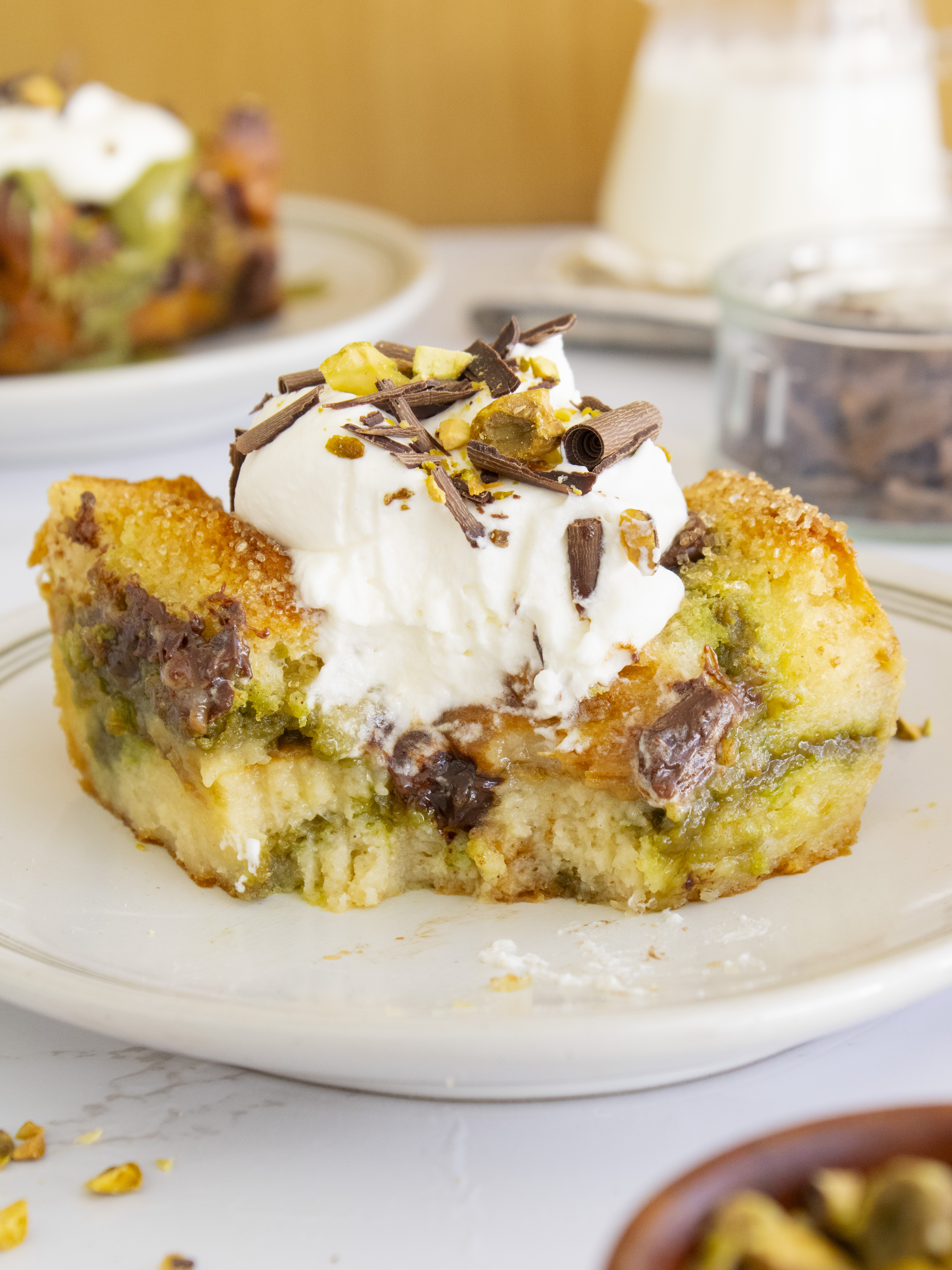 close up of a slice of Pistachio Chocolate Bread Pudding with a bite taken out