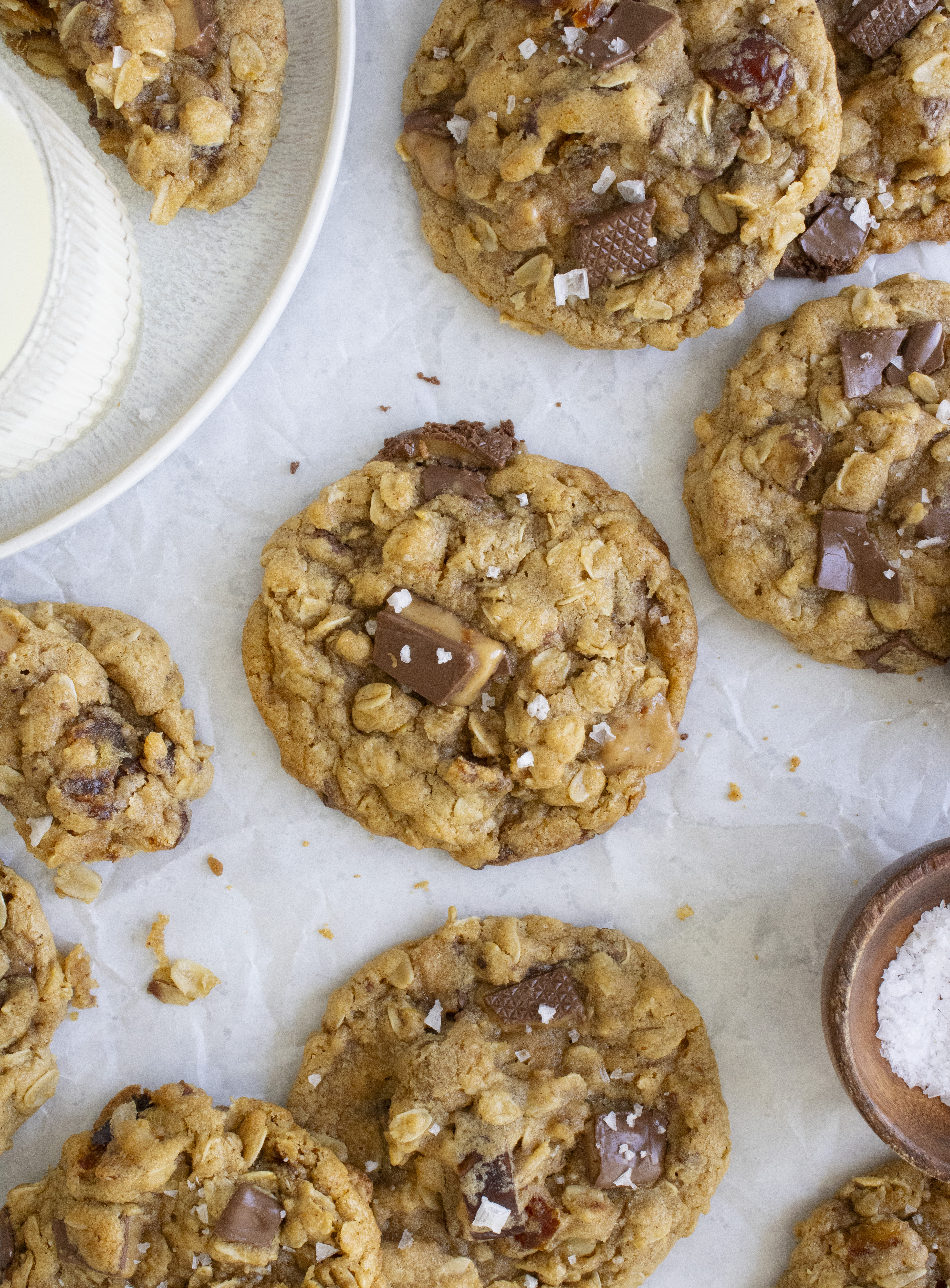 overhead shot of Salted Date and Toffee Oatmeal Cookies on parchment paper