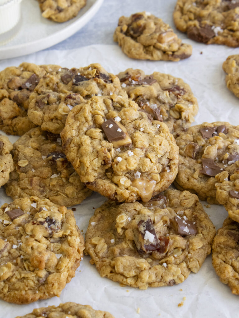 45 degree angle shot of Salted Date and Toffee Oatmeal Cookies laid on top of each other
