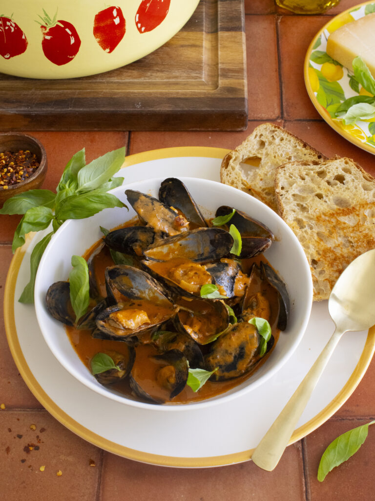 45 degree angle shot of Spicy Vodka Mussels served in a bowl