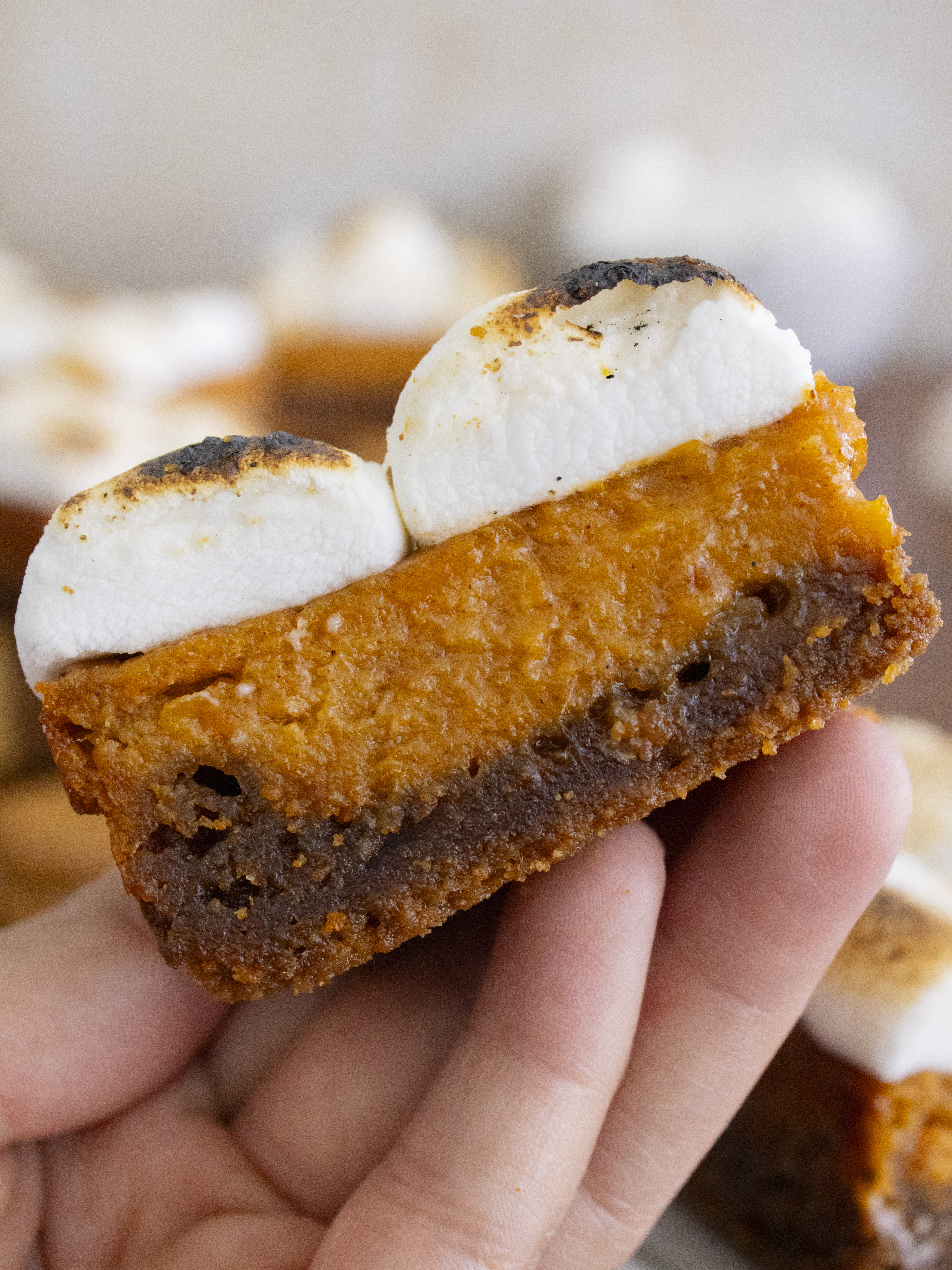 holding a slice of Sweet Potato Pie Bars