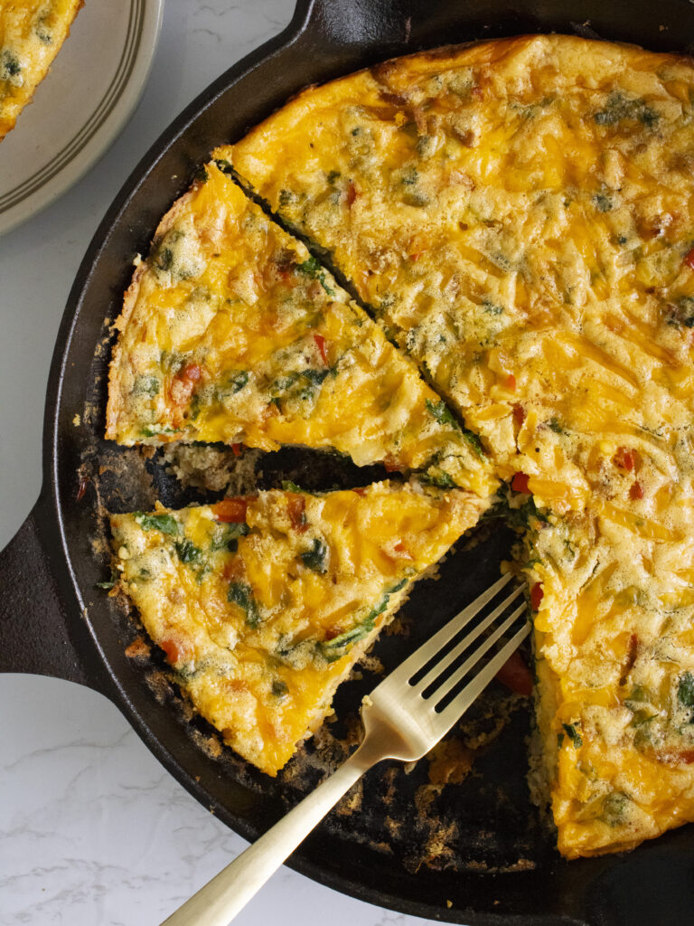 overhead close up of Kale and Sausage Frittata slices in cast iron pan