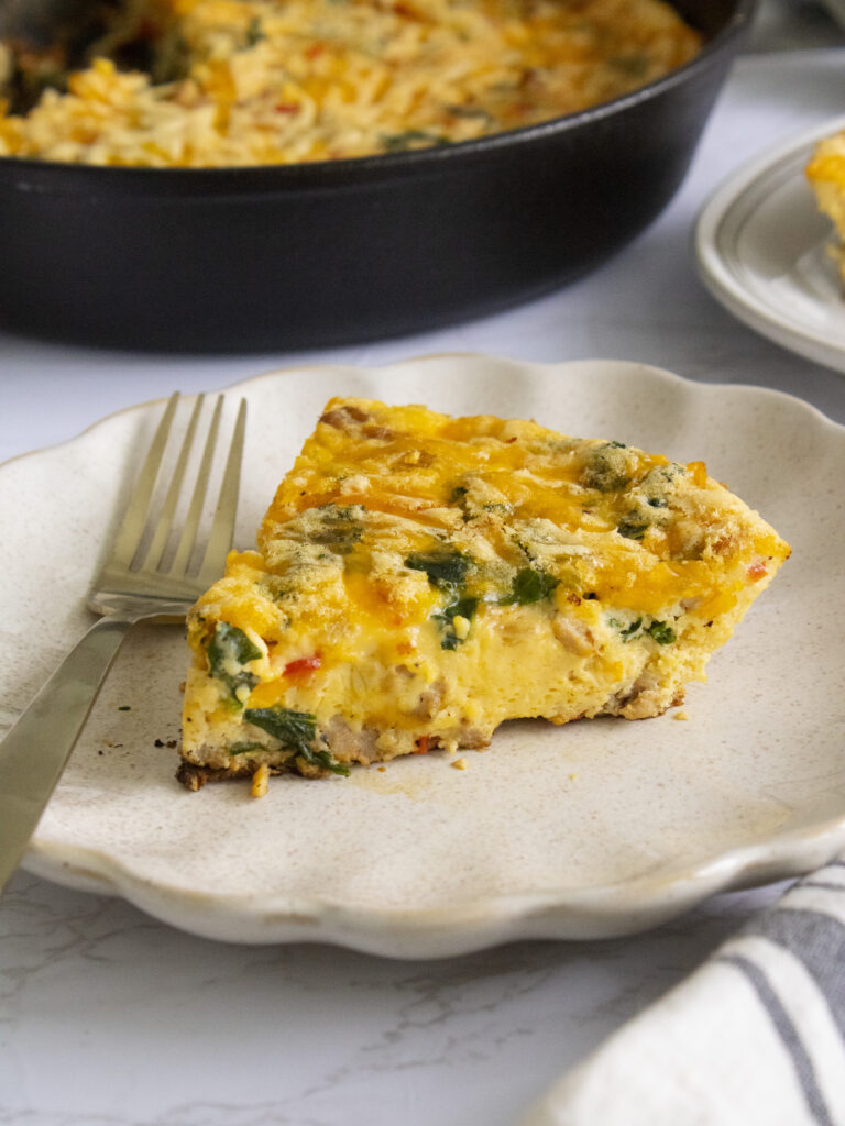close up of a slice of Kale and Sausage Frittata on a plate