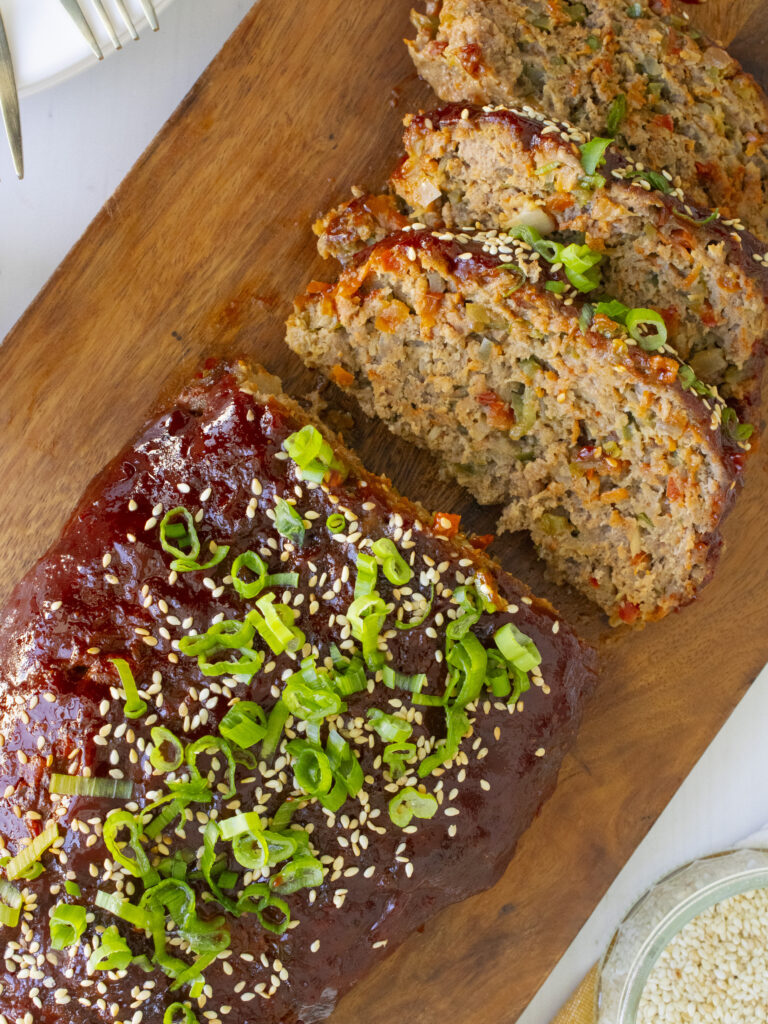 overhead photo of Gochujang Meatloaf sliced on a cutting board
