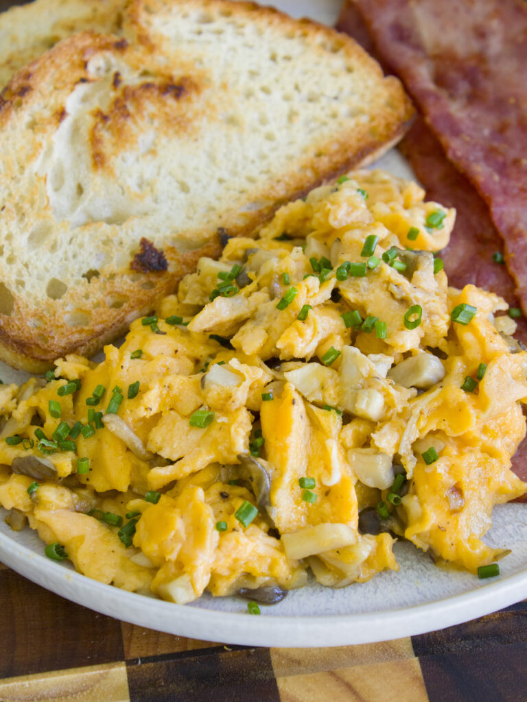 close up of Soft Scrambled Eggs with Mushrooms on a plate