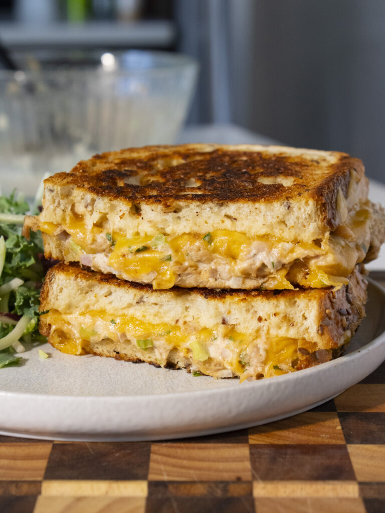 two halves of classic tuna melt stacked on top of each other