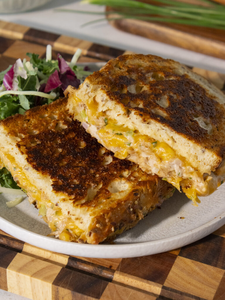 high angle photo of classic tuna melt halves laid on top of each other