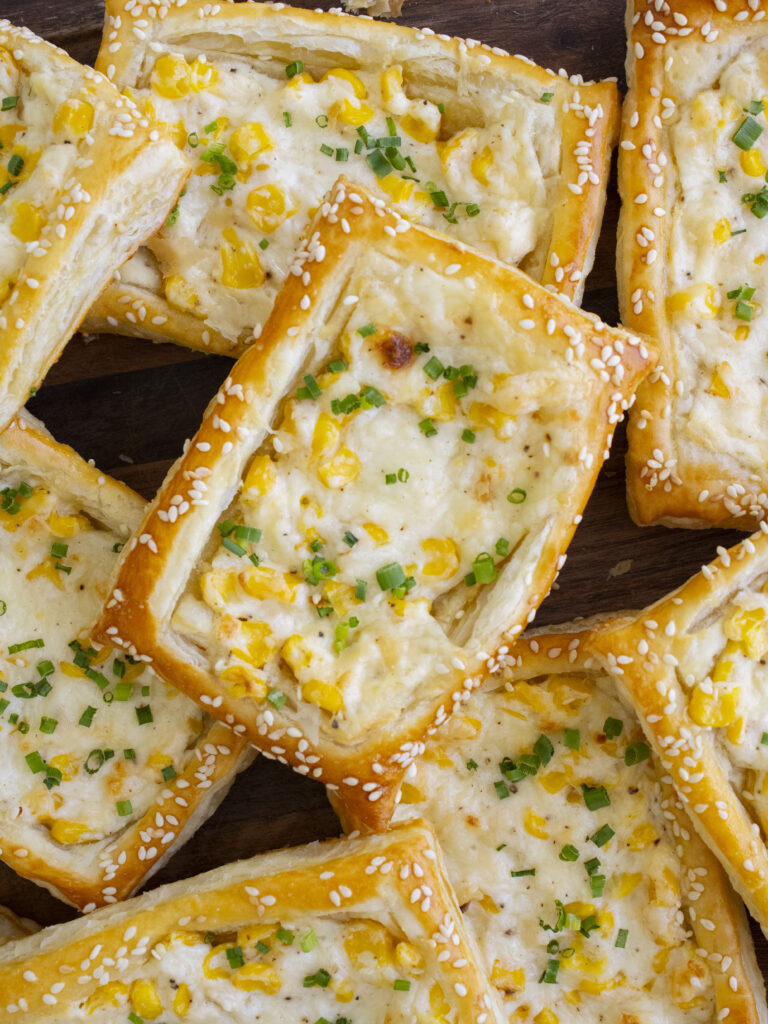 Corn Cheese Puff Pastry Tarts layered on top of each other