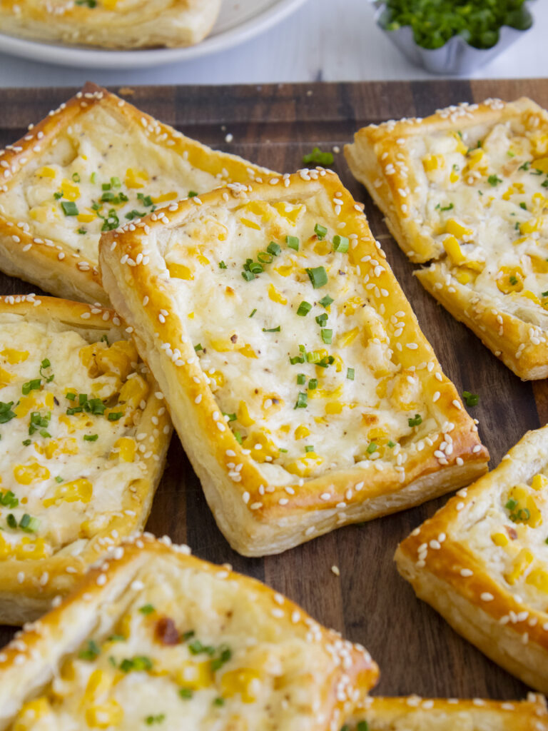 Corn Cheese Puff Pastry Tarts leaning against each other