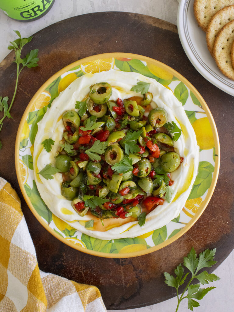 overhead photo of Whipped Ricotta & Olive Dip on a plate