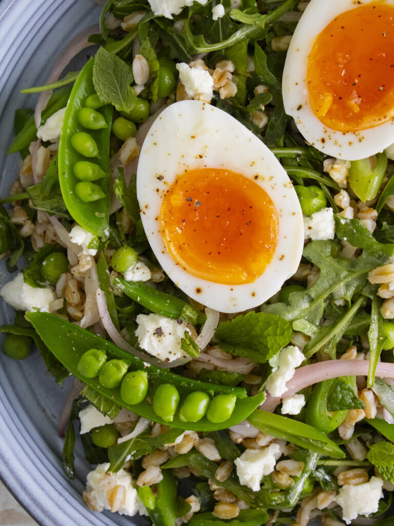 close up of jammy egg and snap pea in Spring Pea Farro Salad