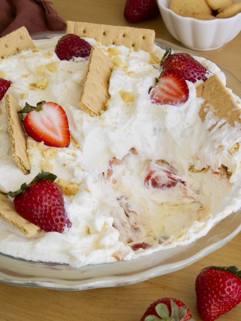 Strawberry Cheesecake Banana Pudding with a scoop taken out