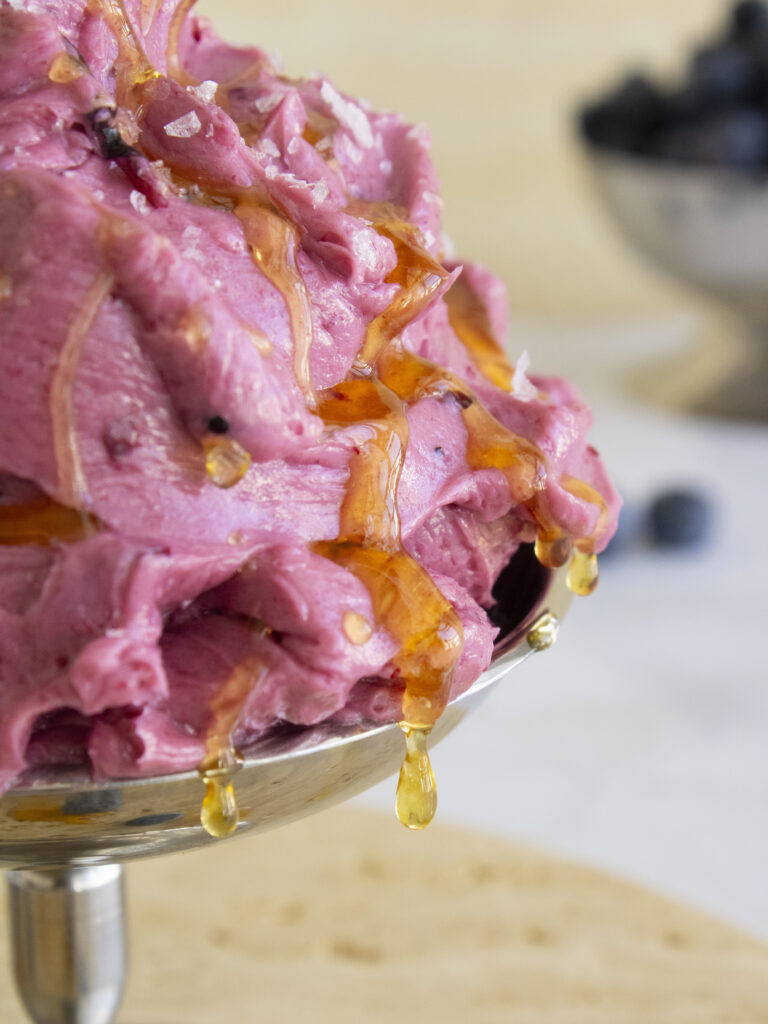 close up of Whipped Blueberry Butter with honey dripping down