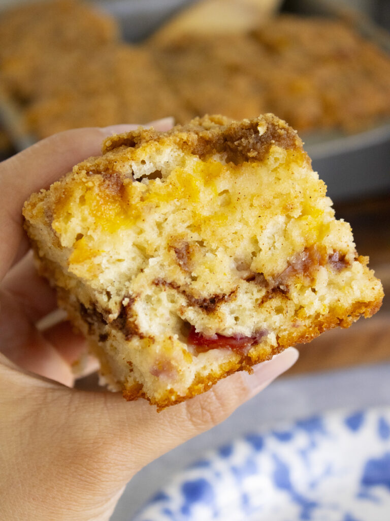 holding a slice of Brown Sugar Peach Butter Swim Biscuits