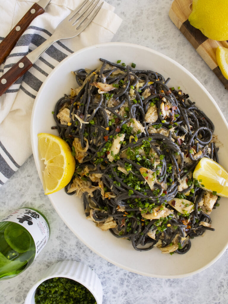 overhead photo of Miso Leek Squid Ink Pasta on serving platter