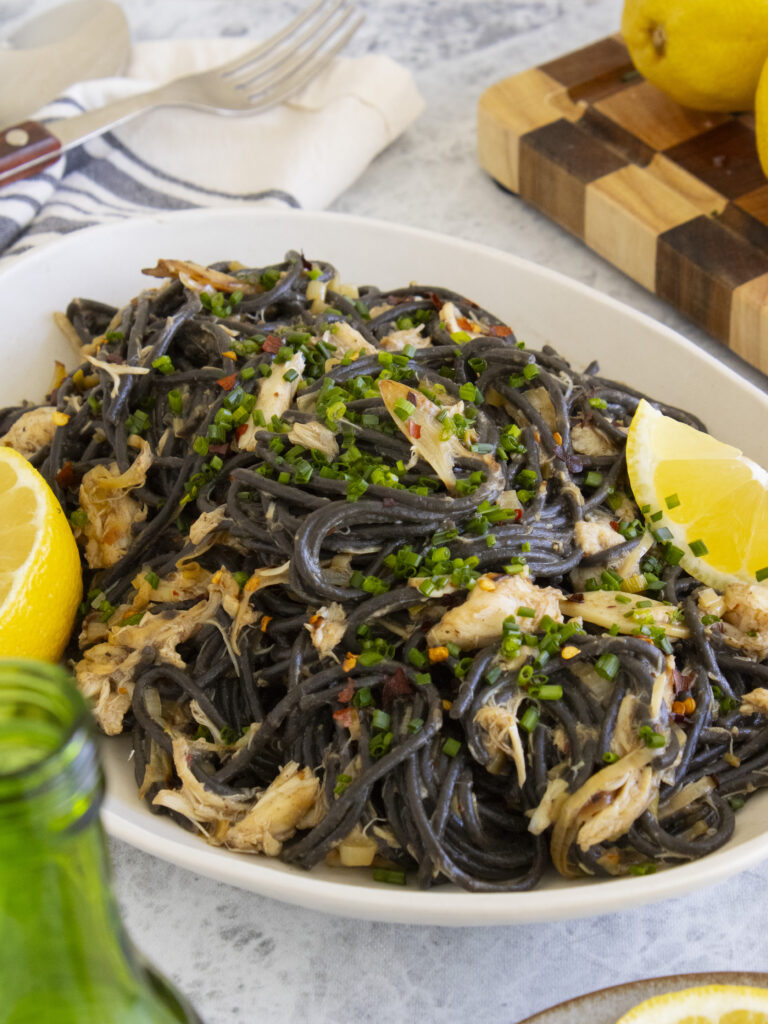 close of of Miso Leek Squid Ink Pasta on a platter